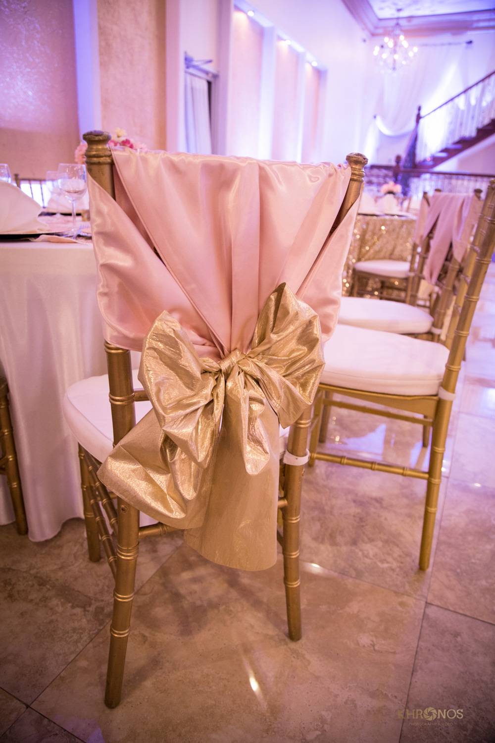 gold chair with pink cloth and gold ribbon decoration - Houston Private Events - Alegria Gardens