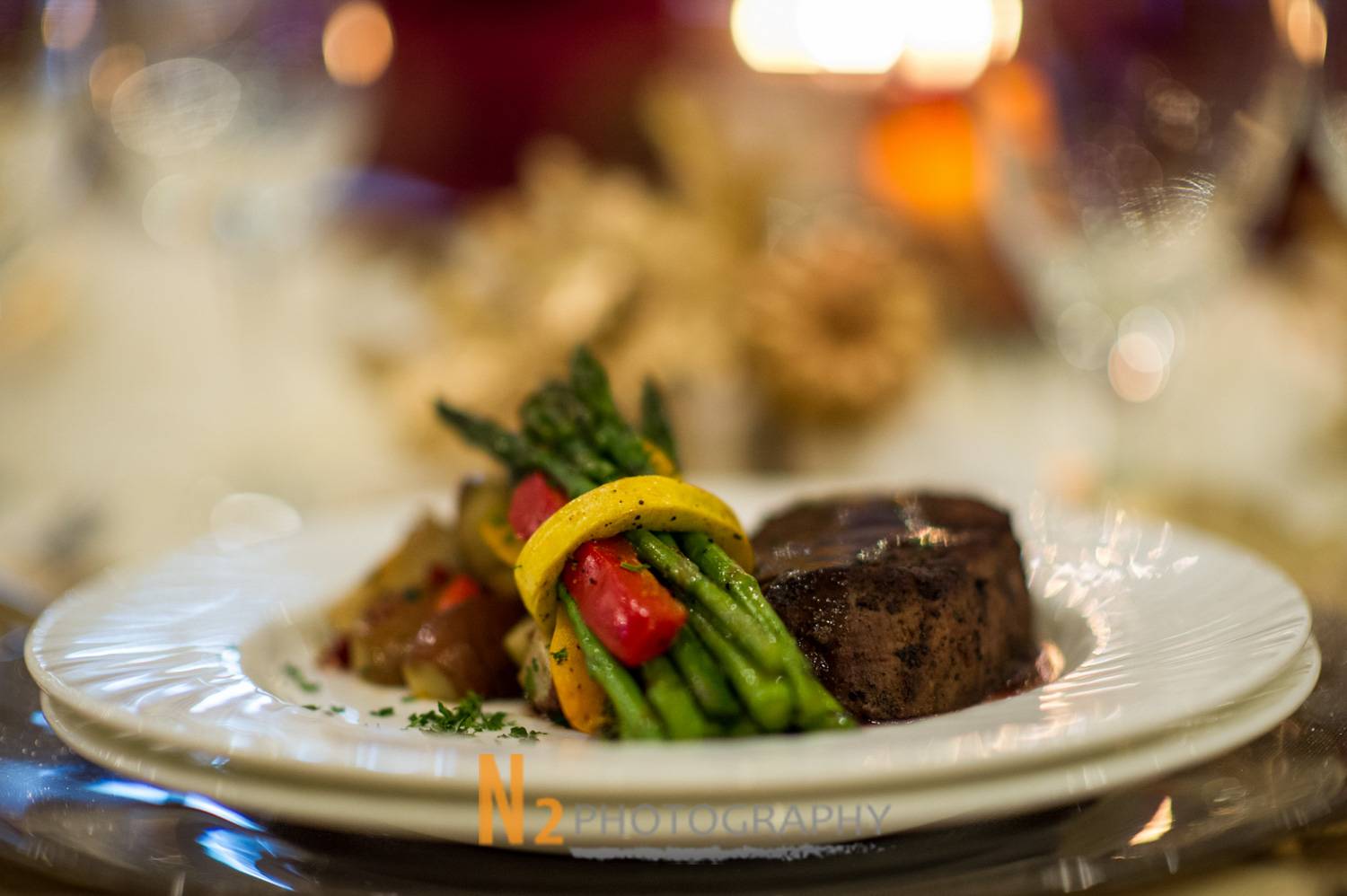 Gourmet plated dinner featuring filet mignon with roasted vegetables, captured by Alegria Gardens, expert event planners in Houston.
