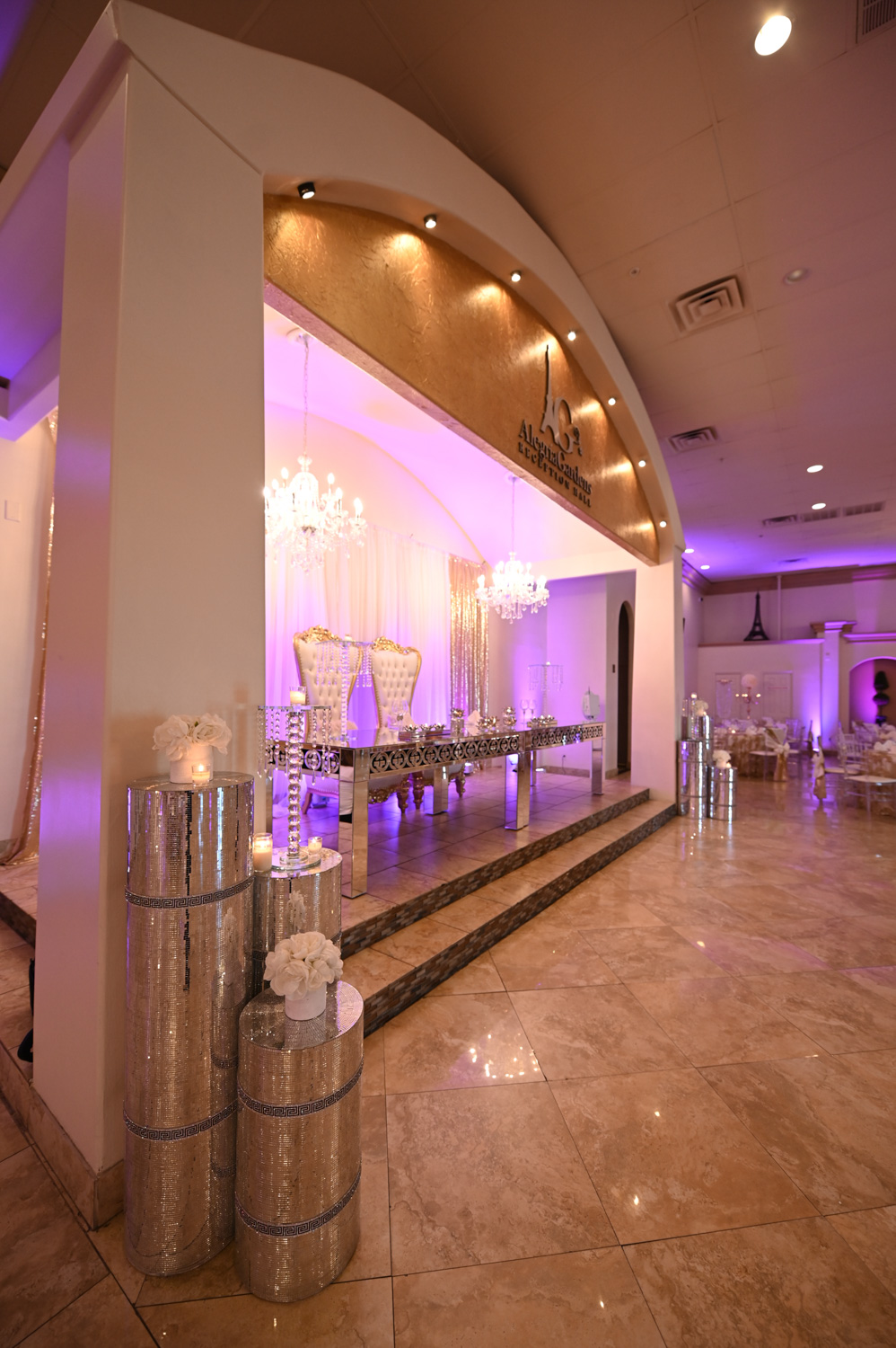 Sophisticated banquet hall interior with modern lighting and elegantly set tables by Alegria Gardens event planners.