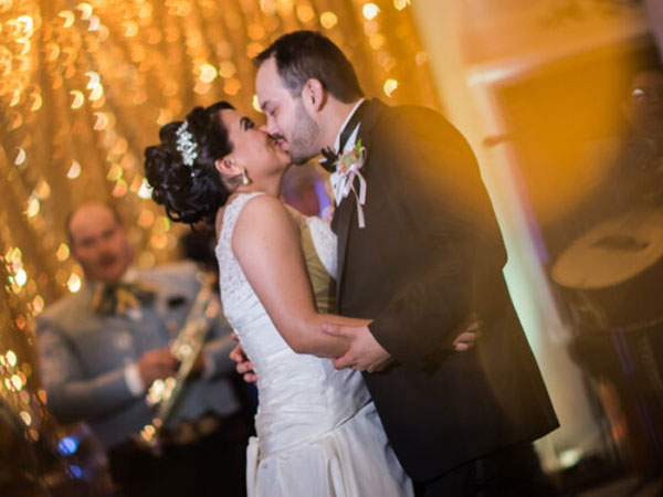Bride and groom kissing at private wedding event organized by Alegria Gardens in Houston.