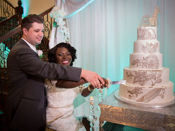 Bride and groom happily cutting their wedding cake - Alegria Gardens