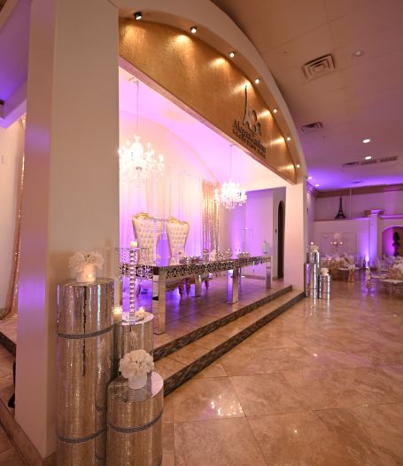 Sophisticated banquet hall interior with modern lighting and elegantly set tables by Alegria Gardens event planners.
